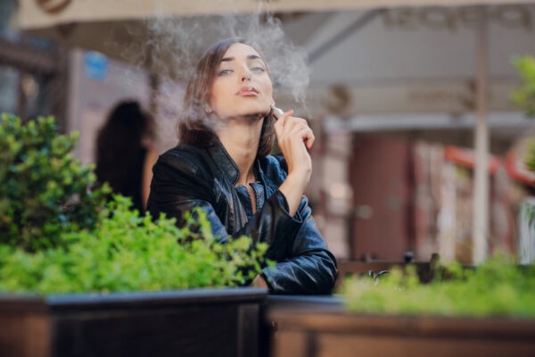 happy woman smoking with electronic cigarette